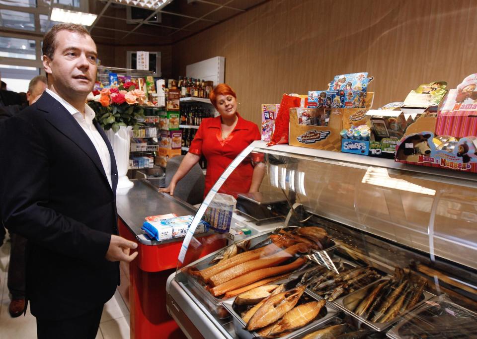FILE - In this July 3, 2012, file photo, Russian Prime Minister Dmitry Medvedev visits a seaside supermarket in the town of Yuzhno-Kurilsk on the Kunashir Island of the Kuril Islands. Japan and the former Soviet Union restored diplomatic relations a decade after World War II, but a dispute over a cluster of islands kept them from signing a peace treaty. Russian President Vladimir Putin is in Japan on Thursday, Dec. 15, 2016 for a two-day talks with Japanese Prime Minister Shinzo Abe on the issue. In 2010 relations cool after Medvedev visits one of the four disputed islands. (Dmitry Astakhov/RIA Novosti Russian Government Pool Photo via AP, File)