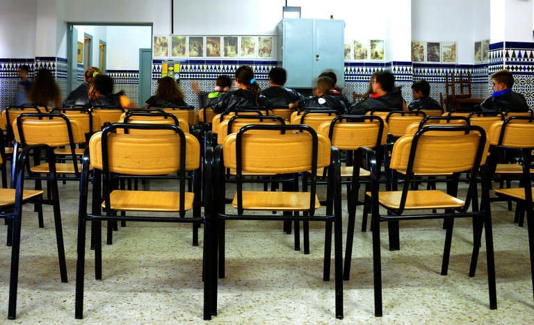 Children during classroom activities in the Parish of San Antonio Abab, in Sevilla, on August 29, 2013. They comes to summer school to learn and play, but above all for the free lunch, a lifeline for many poor families hit by Spain's recession