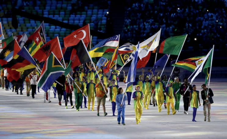 Dozens of countries, including Afghanistan (pictured), had volunteers carrying their flags at the Closing Ceremony Sunday night. (Getty)