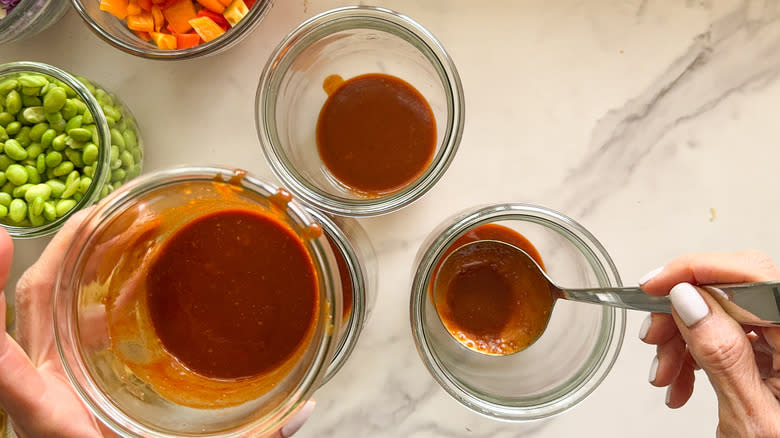 adding sauce to jars