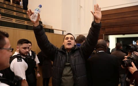 Protestors were escorted out by police - Credit:  SIMON DAWSON/ REUTERS