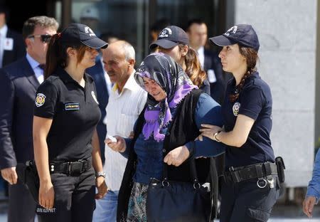 A relative of police officer Muhammet Fatih Sivri mourn during his funeral ceremony in Istanbul, Turkey, July 27, 2015. REUTERS/Osman Orsal