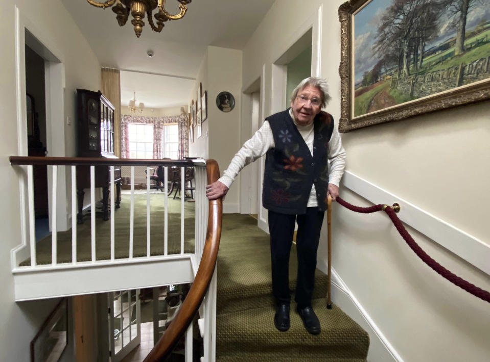 In this undated family handout, Margaret Payne poses for a photo on the stairs of her home in Sutherland, Scotland. Payne, the 90-year-old grandmother who launched an epic climb to raise money for charity completed her fundraiser Tuesday, June 23, 2020 scaling her home’s stairs the equivalent of 731 meters (2,398 feet). That's enough to reach the top of the iconic Scottish peak, Suilven. The feat took her 73 days and kept her busy for 10 weeks while the nation sheltered in lockdown due to the COVID-19 pandemic. (Payne Family via AP)