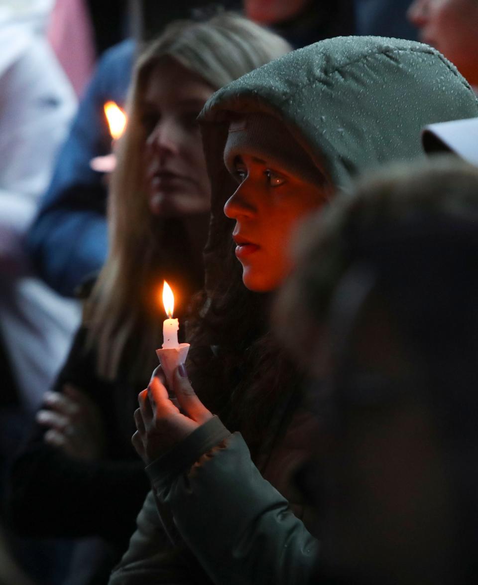 A mourner holds a candle during a vigil in memory of Marbrook Elementary School student James Raul Messick, Friday, May 10, 2024. Messick, who was a month shy of his 11th birthday, died when he was struck on his walk home from school by a vehicle that left the roadway.