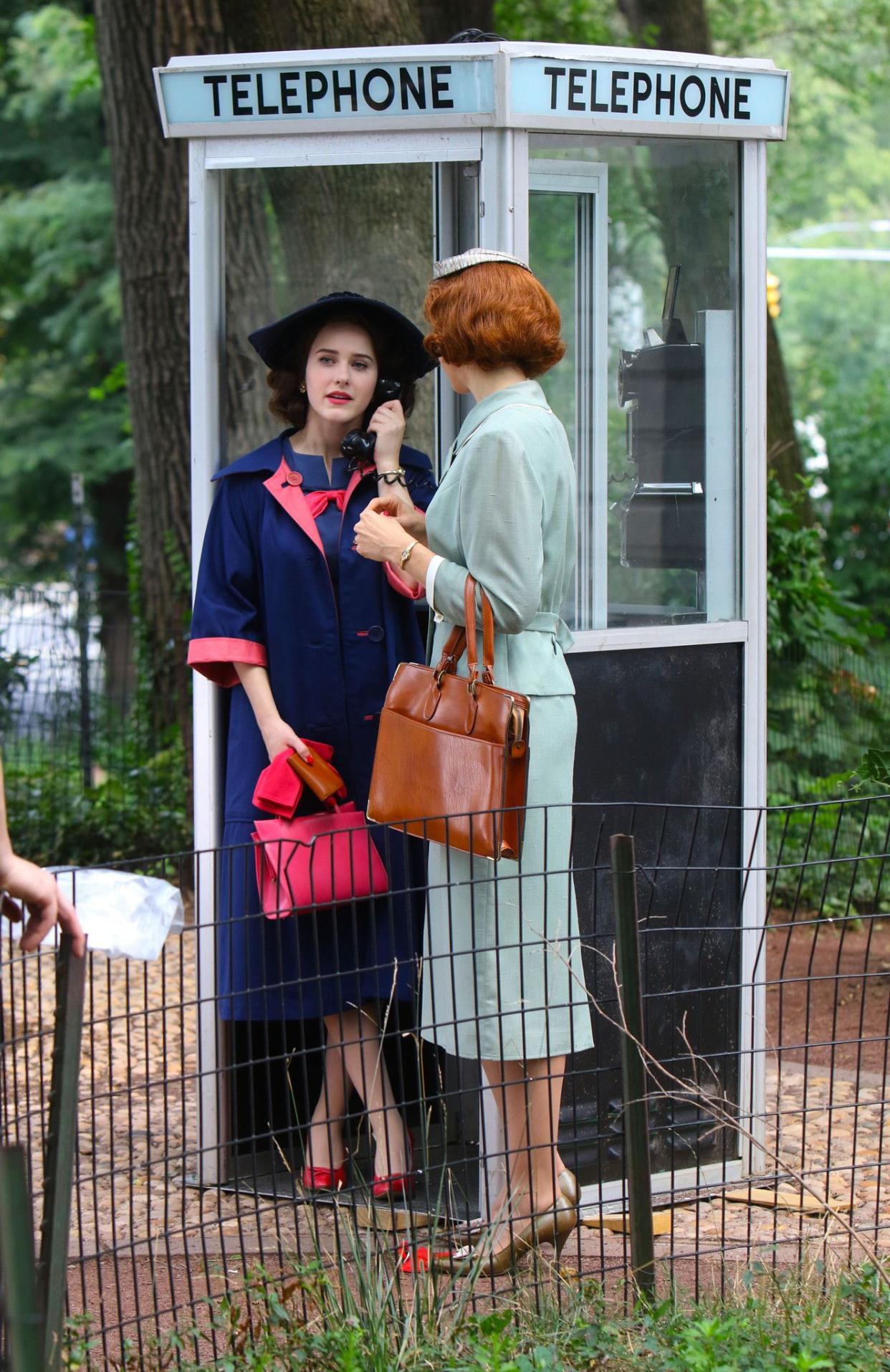 Rachel Brosnahan and a co-star use an old-fashioned telephone booth during a scene for the upcoming season of "The Marvelous Mrs. Maisel" in New York City.