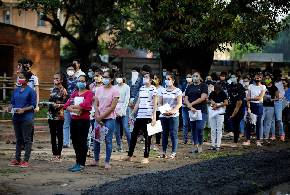 Students wearing protective face masks wait to enter an examination centre for Joint Entrance Examination (JEE), amidst the spread of the coronavirus disease (COVID-19), in Ahmedabad, India, September 1, 2020. REUTERS/Amit Dave