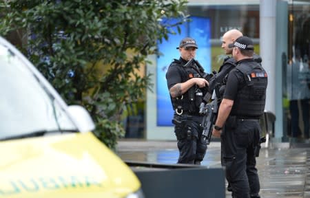 Police officers are seen outside the Arndale shopping centre after several people were stabbed in Manchester