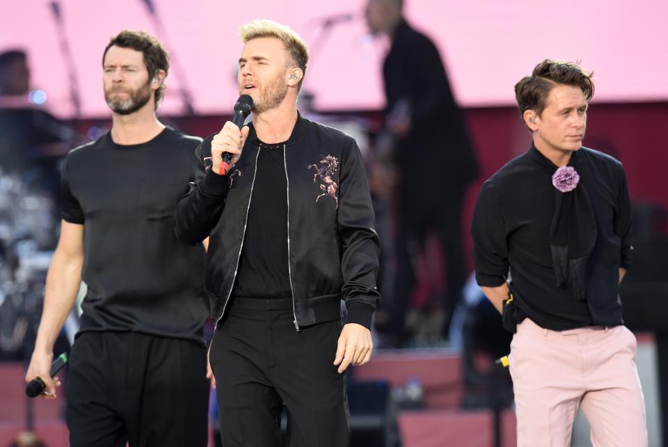 Gary, performing with Take That bandmates Howard and Mark, in Manchester. (Credit: REX)
