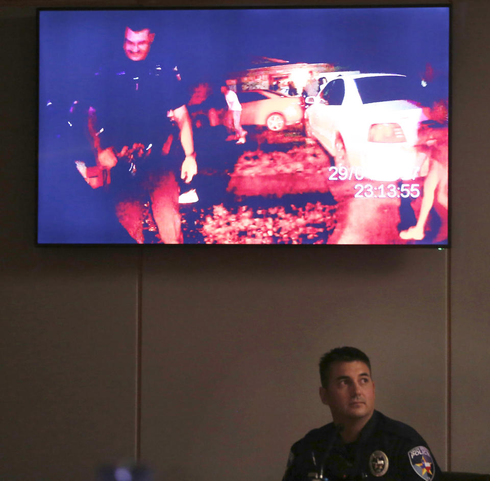 Balch Springs police officer Tyler Gross watches Roy Oliver's body cam footage during his testimony on the first day of the trial of fired Balch Springs police officer Roy Oliver, who is charged with the murder of 15-year-old Jordan Edwards, at the Frank Crowley Courts Building in Dallas on Thursday, Aug. 16, 2018. (Rose Baca/The Dallas Morning News via AP, Pool)