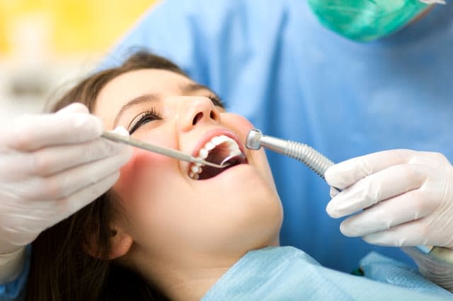 dentist curing a female patient