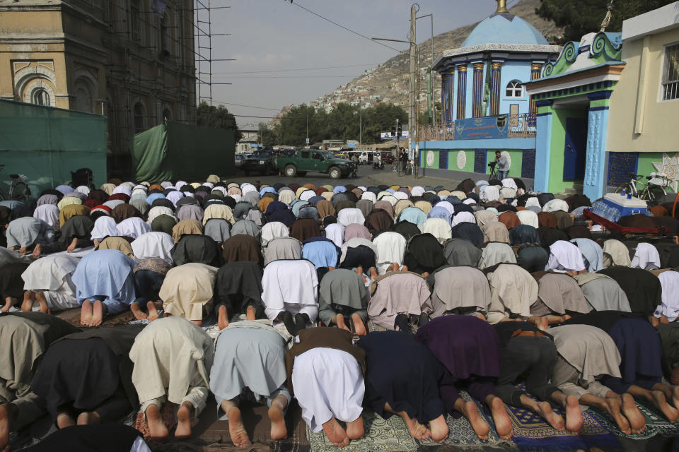 Afghan Muslims offer Eid al-Adha prayers in Kabul, Afghanistan, Sunday, Aug. 11, 2019. Muslim people in the country celebrate Eid al-Adha, or the Feast of the Sacrifice, by slaughtering sheep, goats and cows whose meat will later be distributed to the poor. (AP Photo/Rafiq Maqbool)