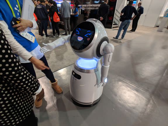 A friendly robot greets a CES attendee.