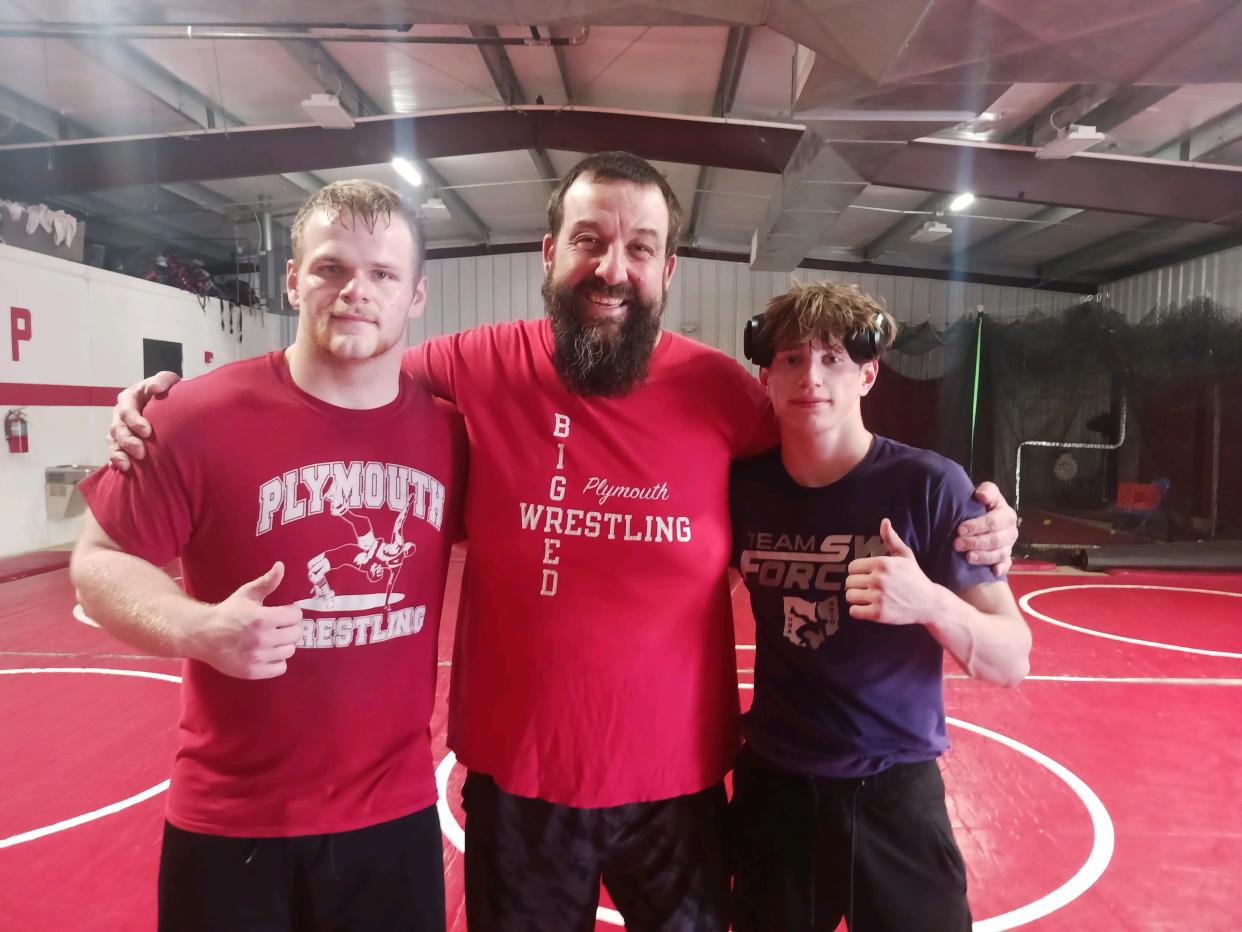 Plymouth coach Jeremiah Balkin flanked by his two state qualifiers, Noah Robinson (left) and Cameron Wagers.