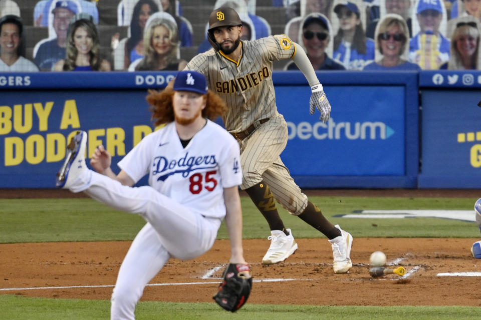 Los Angeles Dodgers starting pitcher Dustin May, left, avoids getting hit by a comeback shot hit by San Diego Padres' Eric Hosmer during the second inning of a baseball game Monday, Aug. 10, 2020, in Los Angeles. (AP Photo/Mark J. Terrill)