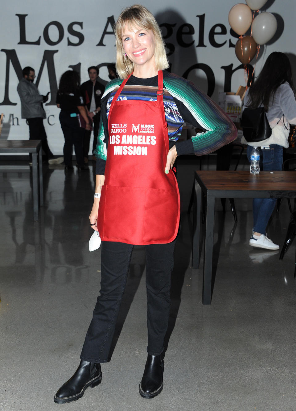 <p>January Jones proudly dons her apron while helping out at the Los Angeles Mission's Thanksgiving event in Downtown L.A. on Nov. 24. </p>