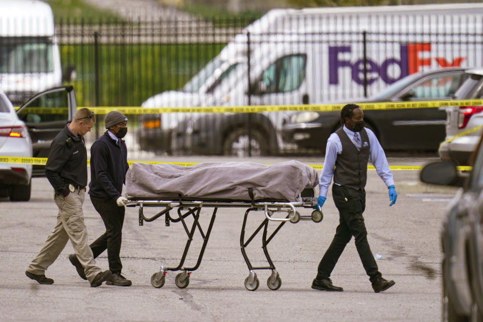 A body is taken from the scene where multiple people were shot at a FedEx Ground facility in Indianapolis, Friday, April 16, 2021. A gunman killed several people and wounded others before taking his own life in a late-night attack at a FedEx facility near the Indianapolis airport, police said. (AP Photo/Michael Conroy)