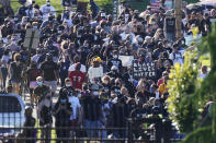 Protesters march past the gates of Churchill Downs racetrack before the 146th running of the Kentucky Derby, Saturday, Sept. 5, 2020, in Louisville, Ky. (AP Photo/Charlie Riedel)