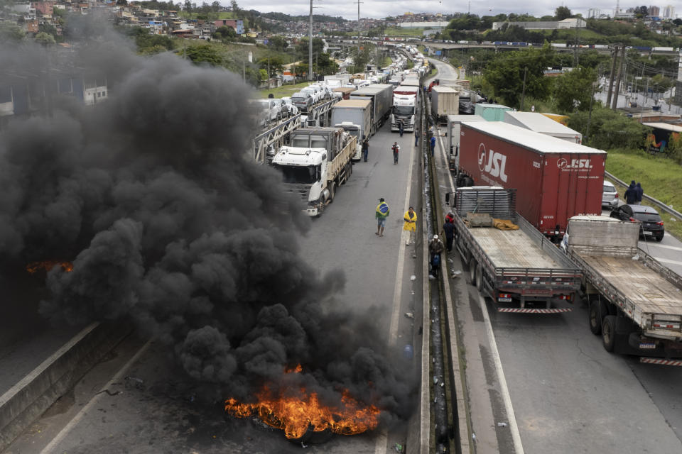 Truckers supportive of President Jair Bolsonaro block a highway to protest his run-off election loss to former President Luiz Inacio Lula da Silva in Embu das Artes on the outskirts of Sao Paulo, Brazil, Tuesday, Nov. 1, 2022. (AP Photo/Andre Penner)