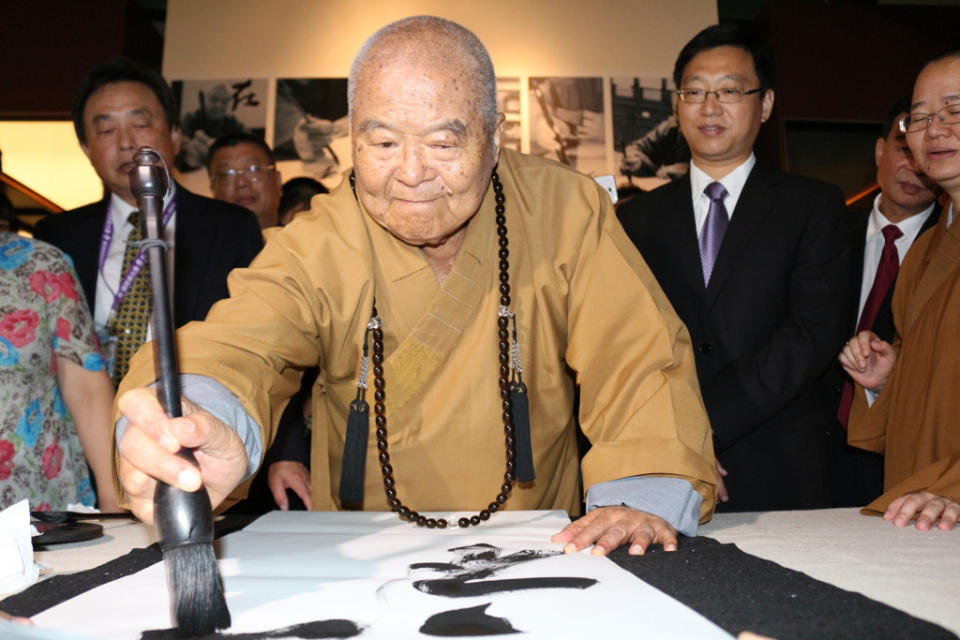 星雲大師擅長書法，圖為2018年他在一筆字廣東展揮毫「禪心」二字贈予廣東省博物館長魏峻。（圖／佛光山提供）