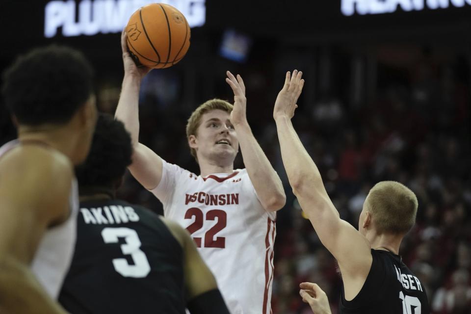 Wisconsin's Steven Crowl shoots over Michigan State's Joey Hauser during the second half of an NCAA college basketball game Tuesday, Jan. 10, 2023, in Madison, Wis. (AP Photo/Morry Gash)