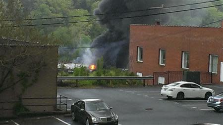 Flames are seen where a CSX Corp train carrying crude oil derailed and burst into flames in downtown Lynchburg, Virginia, April 30, 2014. REUTERS/WSET/Handout via Reuters