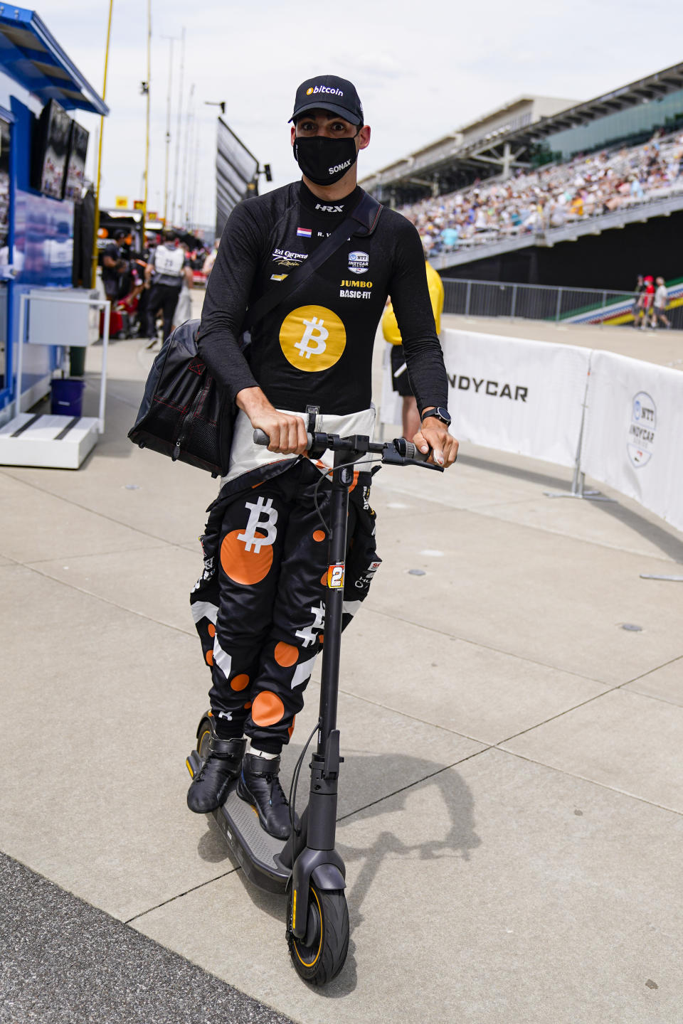 Rinus VeeKay of the Netherlands rides his scooter out of the pit area during practice for the Indianapolis 500 auto race at Indianapolis Motor Speedway in Indianapolis, Friday, May 21, 2021. (AP Photo/Michael Conroy)