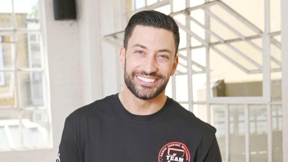 Giovanni Pernice posing in a dance studio