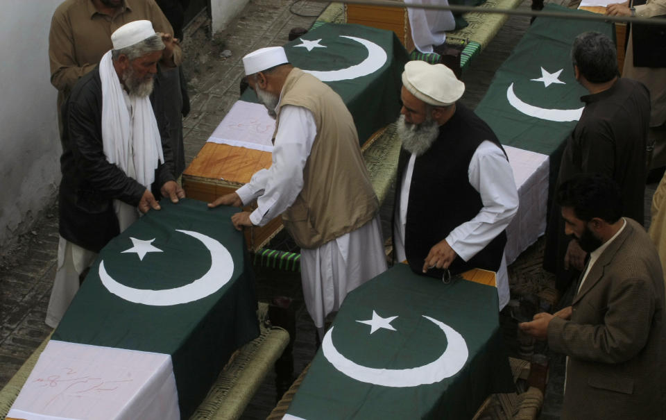 Pakistani relatives of police officers who were killed in Saturday bomb blasts prepare their caskets during their funeral, in Jamrud, near Peshawar, Pakistan, Saturday, March 1, 2014. The Pakistani Taliban announced Saturday that the group will observe a one-month cease-fire as part of efforts to negotiate a peace deal with the government, throwing new life into a foundering peace process. The violence Saturday showed how difficult it could be to enforce a cease-fire, let alone forge a peace agreement. (AP Photo/Mohammad Sajjad)