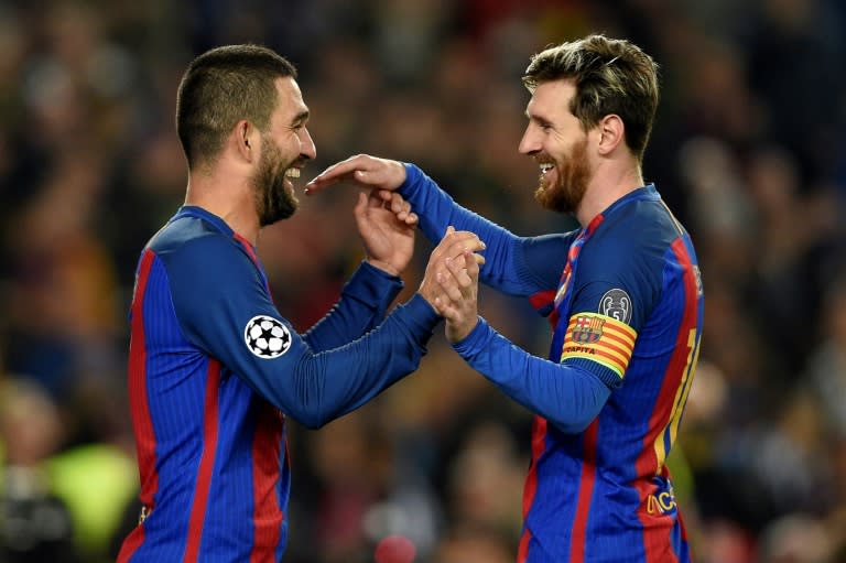 Barcelona's Arda Turan (L) celebrates with teammate Lionel Messi after scoring a goal during their UEFA Champions League Group C match against Borussia Moenchengladbach, at the Camp Nou stadium in Barcelona, on December 6, 2016