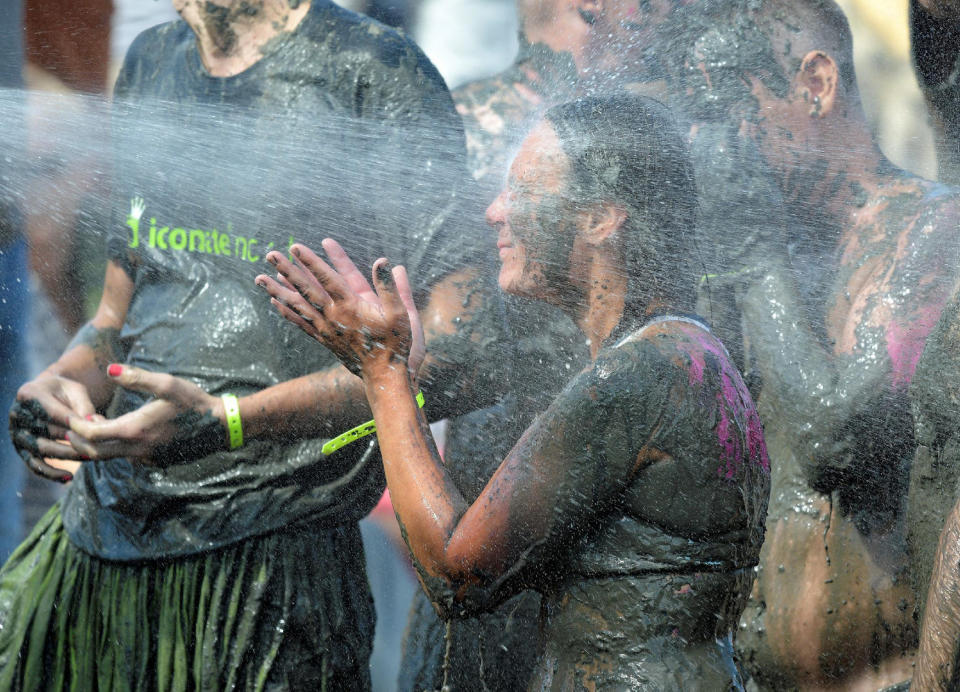 <p>A participant is sprinkled with water after a handball match at the so called “Wattoluempiade” (Mud Olympics) in Brunsbuettel at the North Sea, Germany July 30, 2016. (REUTERS/Fabian Bimmer) </p>