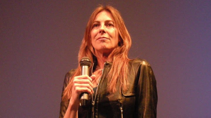 Kathryn Bigelow at an event holding a microphone.