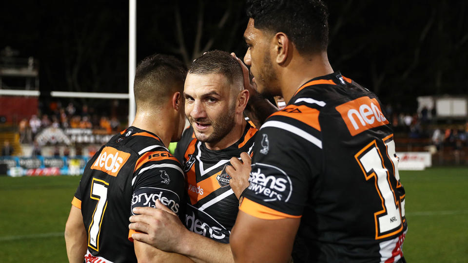 Robbie Farah is congratulated by teammates during the Tigers' win over the Cowboys. 