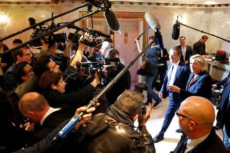 Marine Le Pen French National Front (FN) political party leader and candidate for French 2017 presidential election and Debout La France group former candidate Nicolas Dupont-Aignan leave after a news conference in Paris, France, April 29, 2017. REUTERS/Charles Platiau