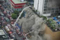 Thick smoke covers several floors of the Waterfront Manila Pavilion building after a fire broke out