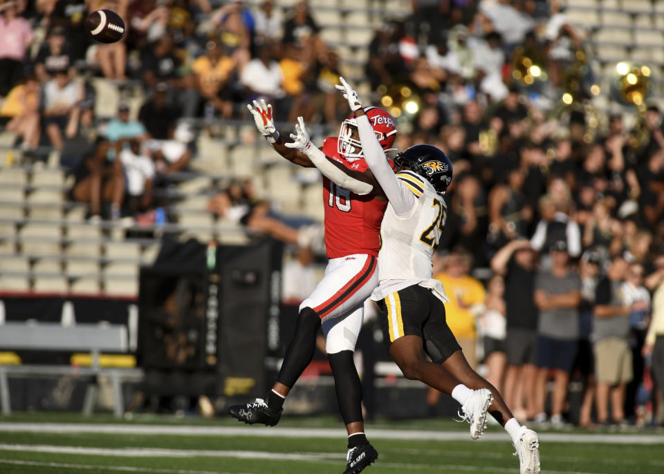 Towson defensive back CJ McClendon (25) breaks up a pass intended for Maryland tight end Dylan Wade (18) during the second half of an NCAA college football game Saturday, Sept. 2, 2023, in College Park, Md. Maryland won 38-6. (AP Photo/Steve Ruark)