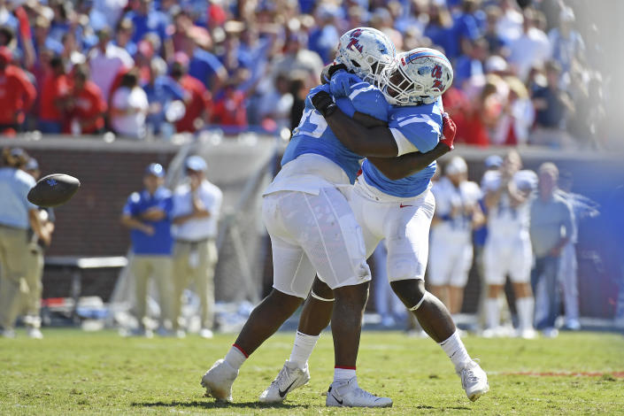 Mississippi defensive tackle JJ Pegues (89) and defensive end Cedric Johnson (2) react after a fumble recovery during the second half of an NCAA college football game against Kentucky in Oxford, Miss., Saturday, Oct. 1, 2022. Mississippi won 22-19. (AP Photo/Thomas Graning)