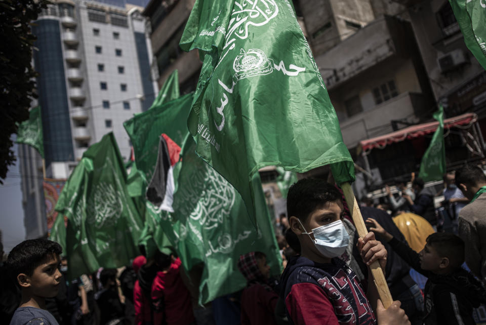 Palestinians hold Hamas movement green flags attend a protest in solidarity with Muslim worshippers in Jerusalem, in Gaza City, Friday, April. 23, 2021. (AP Photo/Khalil Hamra)