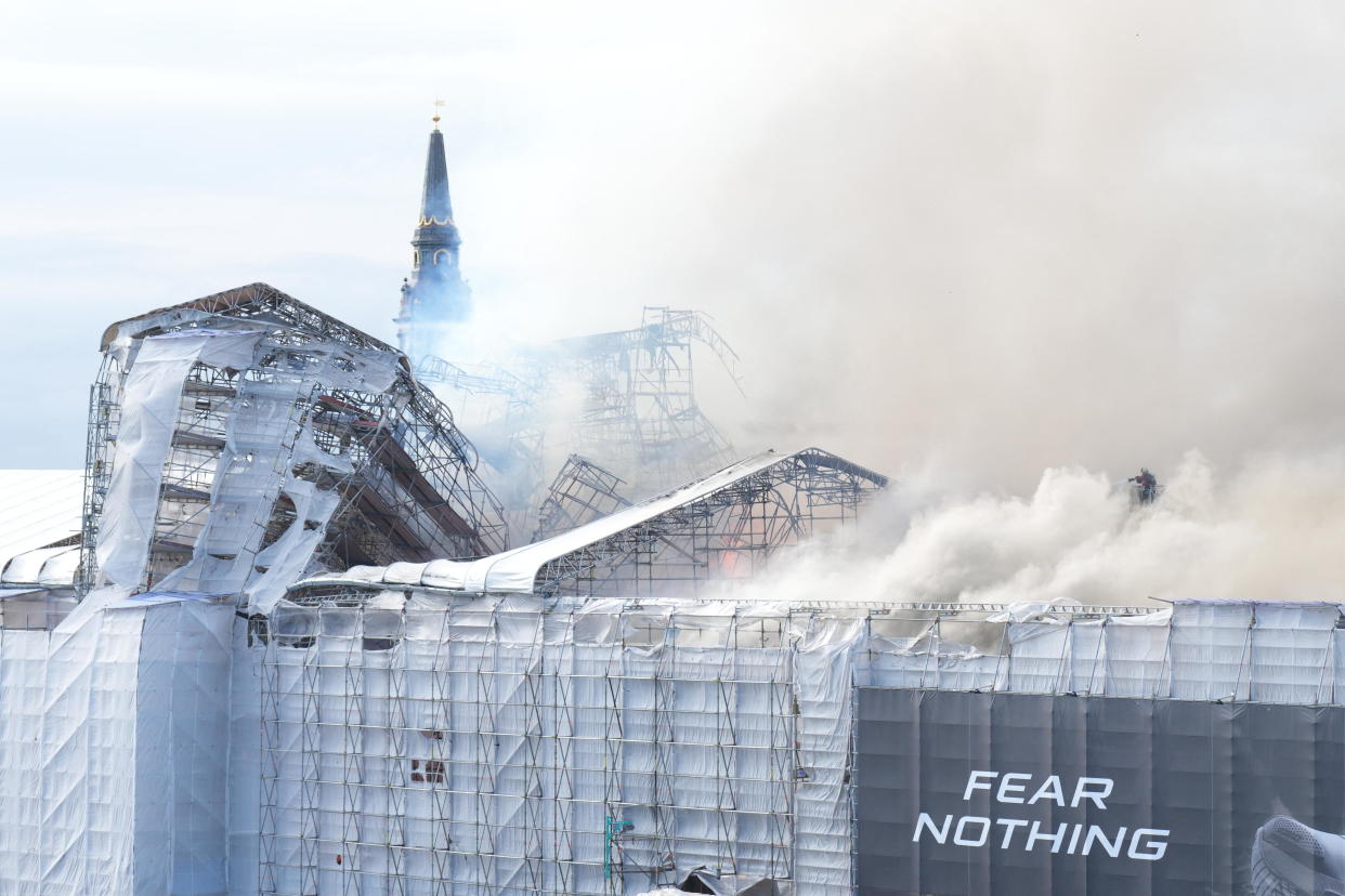 Plumes of smoke billow from the historic Boersen stock exchange building which is on fire in central Copenhagen, Denmark on April 16, 2024. The building, one of the oldest in the Danish capital, was undergoing renovation work when in the morning it caught fire, whose cause was yet unknown. The building was erected in the 1620s as a commercial building by King Christian IV and is located next to the Danish parliament. / Credit: EMIL HELMS/Ritzau Scanpix/AFP via Getty Images