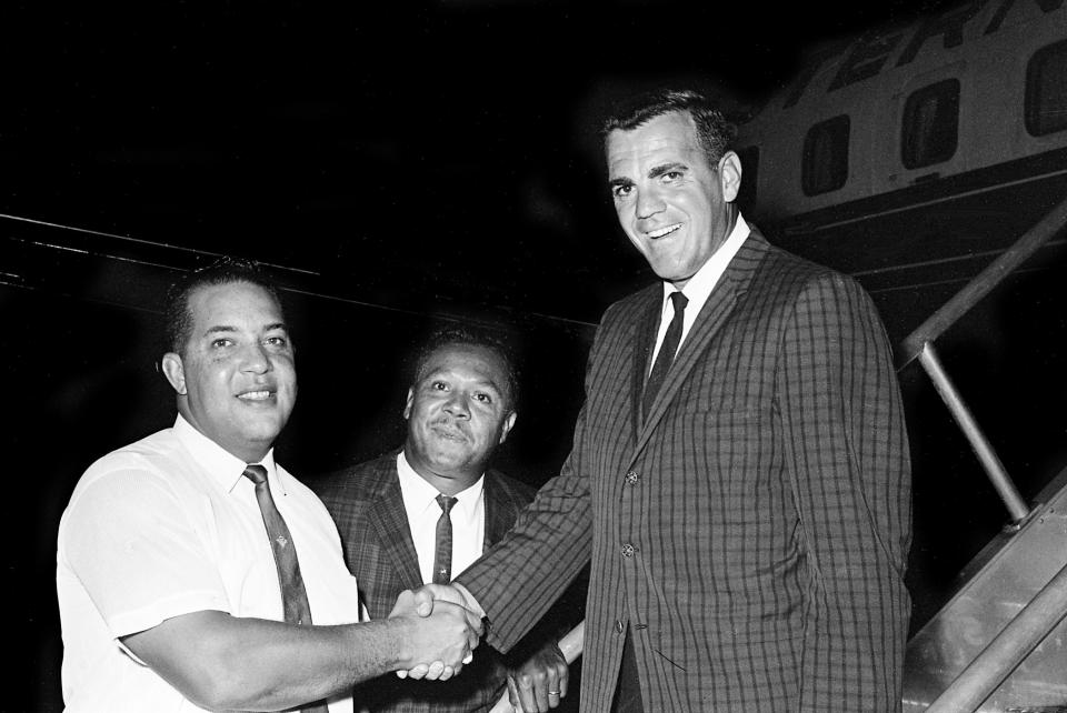 Ara Parseghian, right, Norte Dame new head football coach, is greeted upon arriving at Berry Field July 22, 1964 by John Merritt, left, grid coach at Tennessee State, and Harvey Gentry, Tennessee State athletic director. Parseghian is in town to opens the seventh annual Blue Ribbon Coaching Clinic at Tennessee State the next morning.