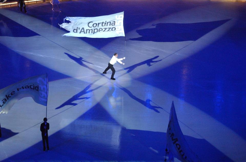 A lone skater carries a flag during the Salt Lake 2002 Winter Games opening ceremony at the University of Utah’s Rice-Eccles Stadium on Friday, Feb. 8, 2002. | Johanna Kirk, Deseret News