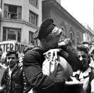 <p>A couple kisses in Times Square as they partake in V-E Day celebrations.</p>