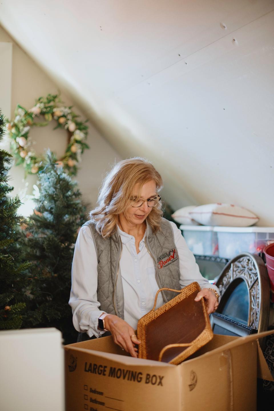 Cheryl Smith organizes a storage closet to better label and arrange décor and seasonal items.