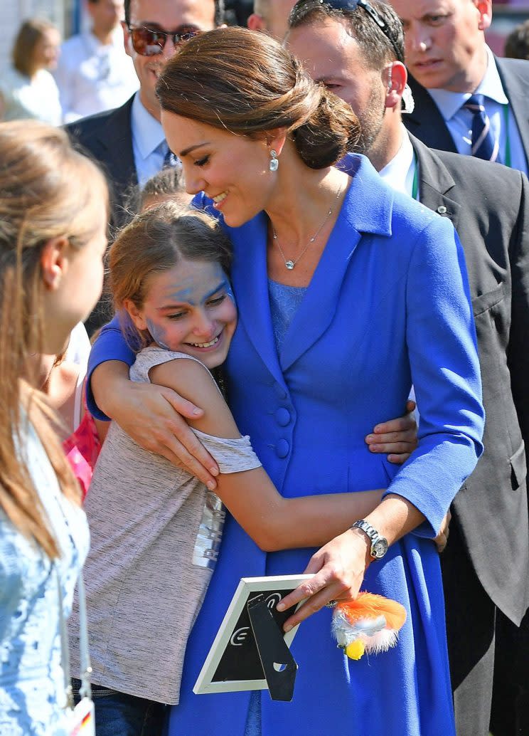 Kate was pictured hugging children on the streets of Berlin. (Photo: PA)