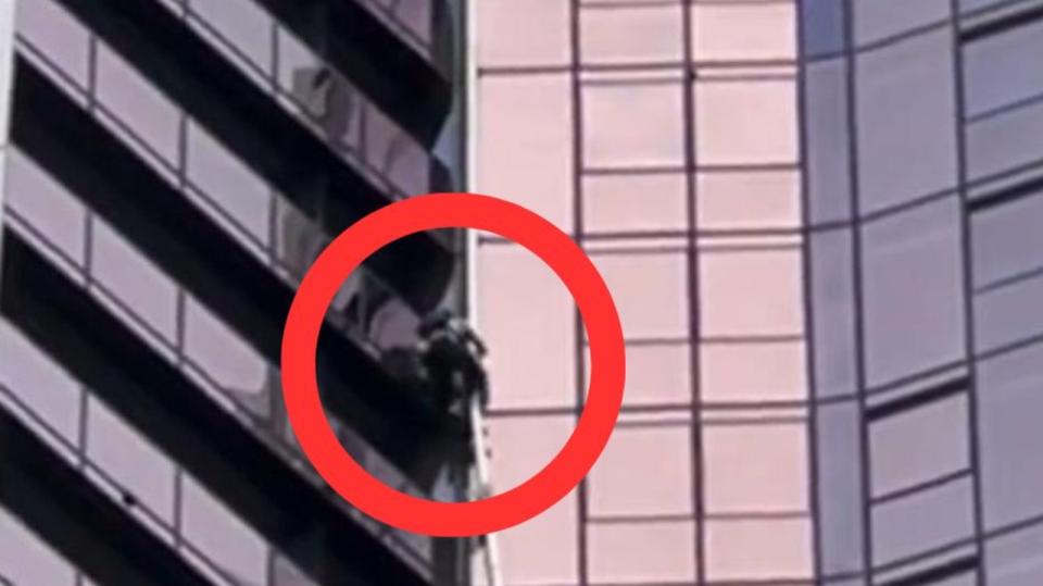 The man was seen scaling the building on Tuesday