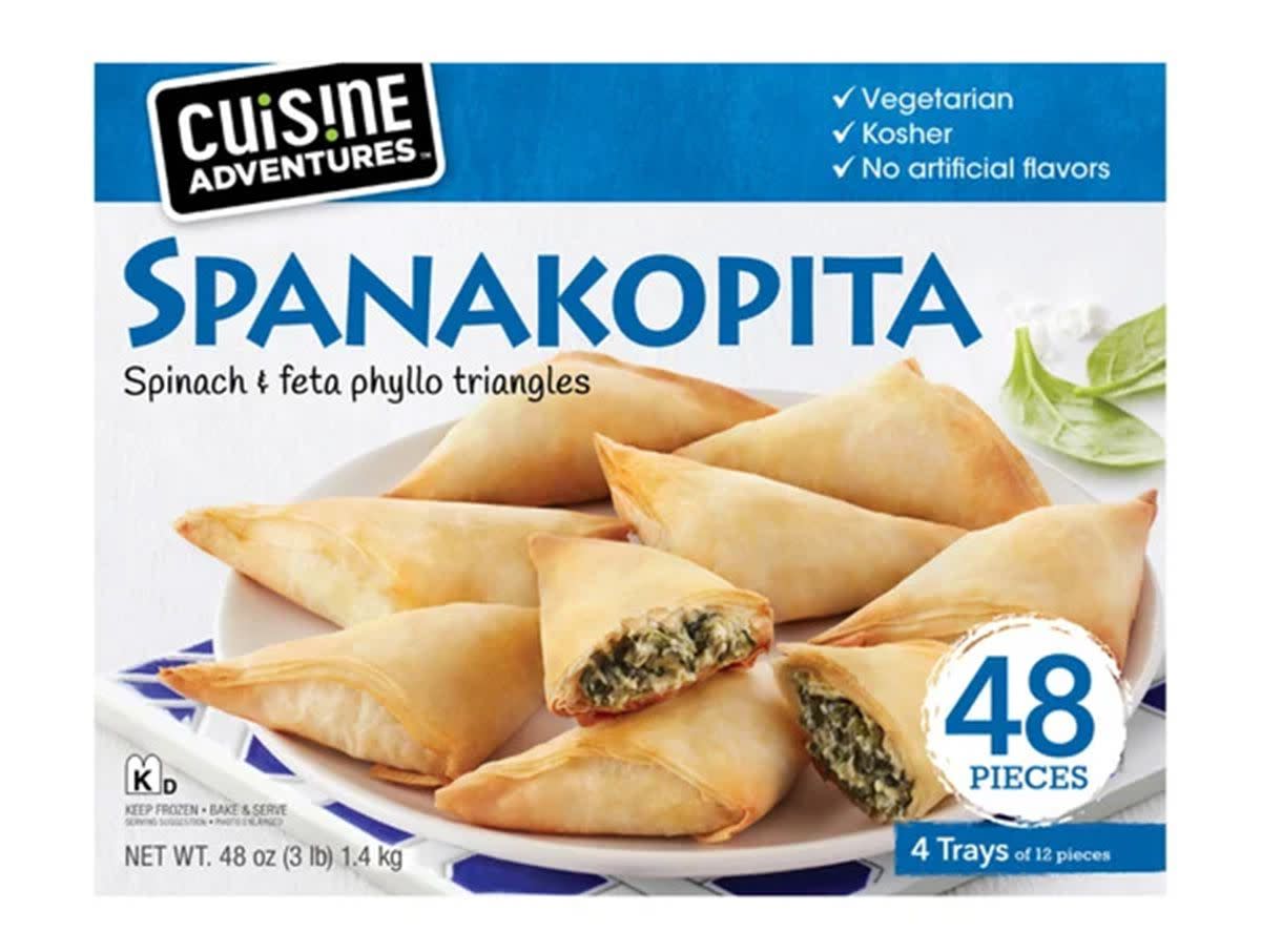 A package of Cuisine Adventures Spanakopita Spinach & Feta Phyllo Triangles against a white background