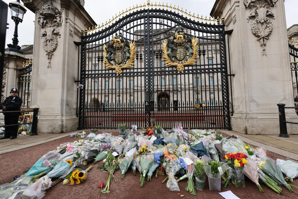 LONDON, ENGLAND - SEPTEMBER 09: General view of flowers at the gates of Buckingham Palace on September 09, 2022 in London, England. Elizabeth Alexandra Mary Windsor was born in Bruton Street, Mayfair, London on 21 April 1926. She married Prince Philip in 1947 and acceded the throne of the United Kingdom and Commonwealth on 6 February 1952 after the death of her Father, King George VI. Queen Elizabeth II died at Balmoral Castle in Scotland on September 8, 2022, and is succeeded by her eldest son, King Charles III. (Photo by Neil Mockford/Getty Images)