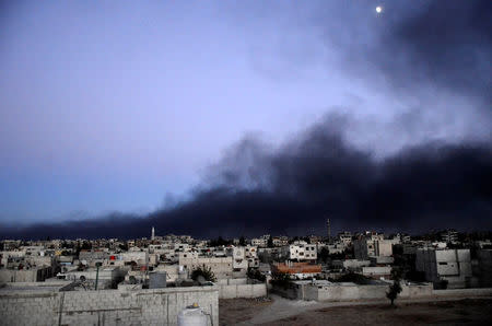 FILE PHOTO: Smoke rises into the sky from what activists said was Free Syrian Army fighters destroying a tank that belonged to forces loyal to Syria's President Bashar al-Assad in the Qaboun area, Eastern Ghouta, Syria September 15, 2013. REUTERS/Bassam Khabieh/File Photo