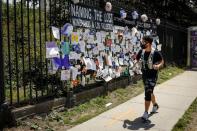 A man looks at a memorial for those who have died from the coronavirus outside The Green-Wood Cemetery, during the outbreak of the coronavirus disease (COVID-19) in Brooklyn, New York