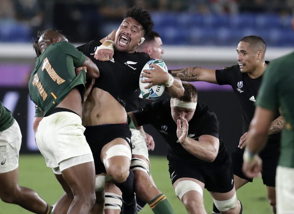 New Zealand's Ardie Savea reacts as he is tackled by South Africa's Makazole Mapimpi, left, during the Rugby World Cup Pool B game at International Stadium between New Zealand and South Africa in Yokohama, Japan, Saturday, Sept. 21, 2019. (AP Photo/Jae Hong)