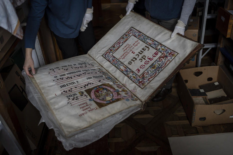 Workers at the rare manuscripts and old printed books department of the Andrey Sheptytsky National Museum store them in cardboard boxes to reduce the risk of damage in the event of an attack in the western Ukrainian city of Lviv, Friday, March 4, 2022. (AP Photo/Bernat Armangue)